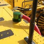 Nonpressure fuel overfill prevention system installed on a Komatsu PC2000.
